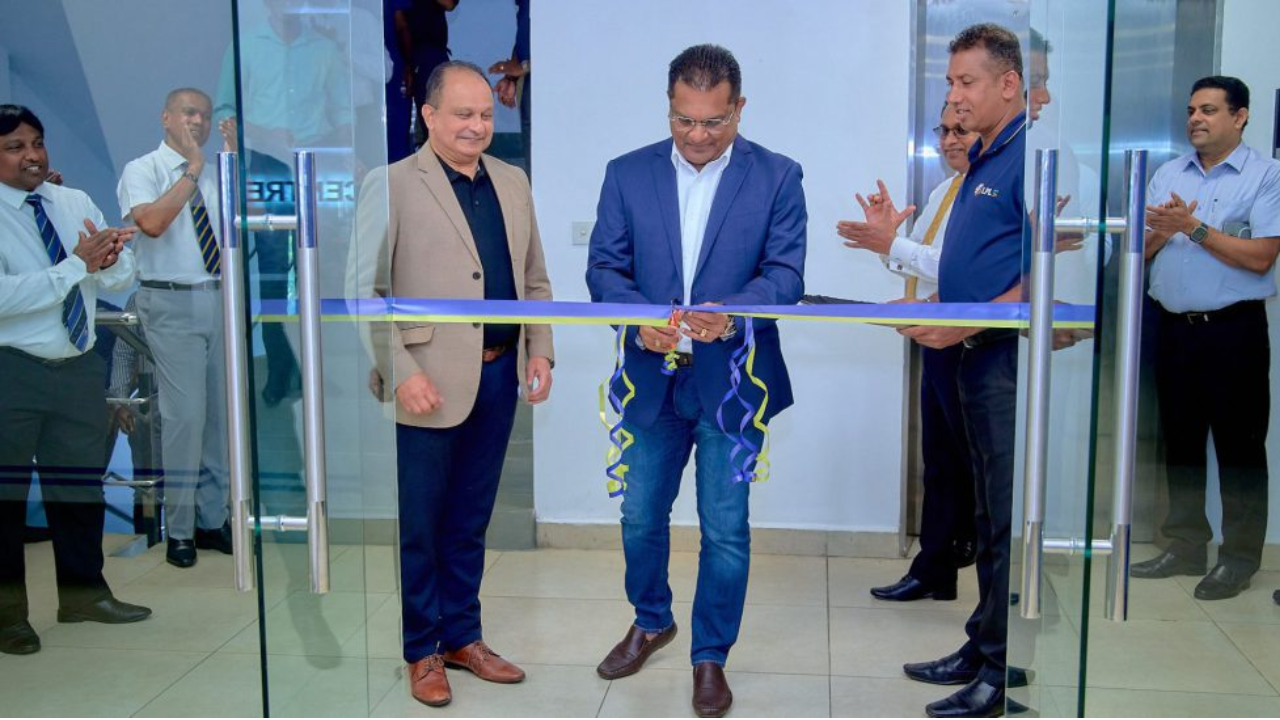 SLC President Shammi Silva cutting a ribbon during the inauguration of the Brain Centre, surrounded by officials and staff applauding.