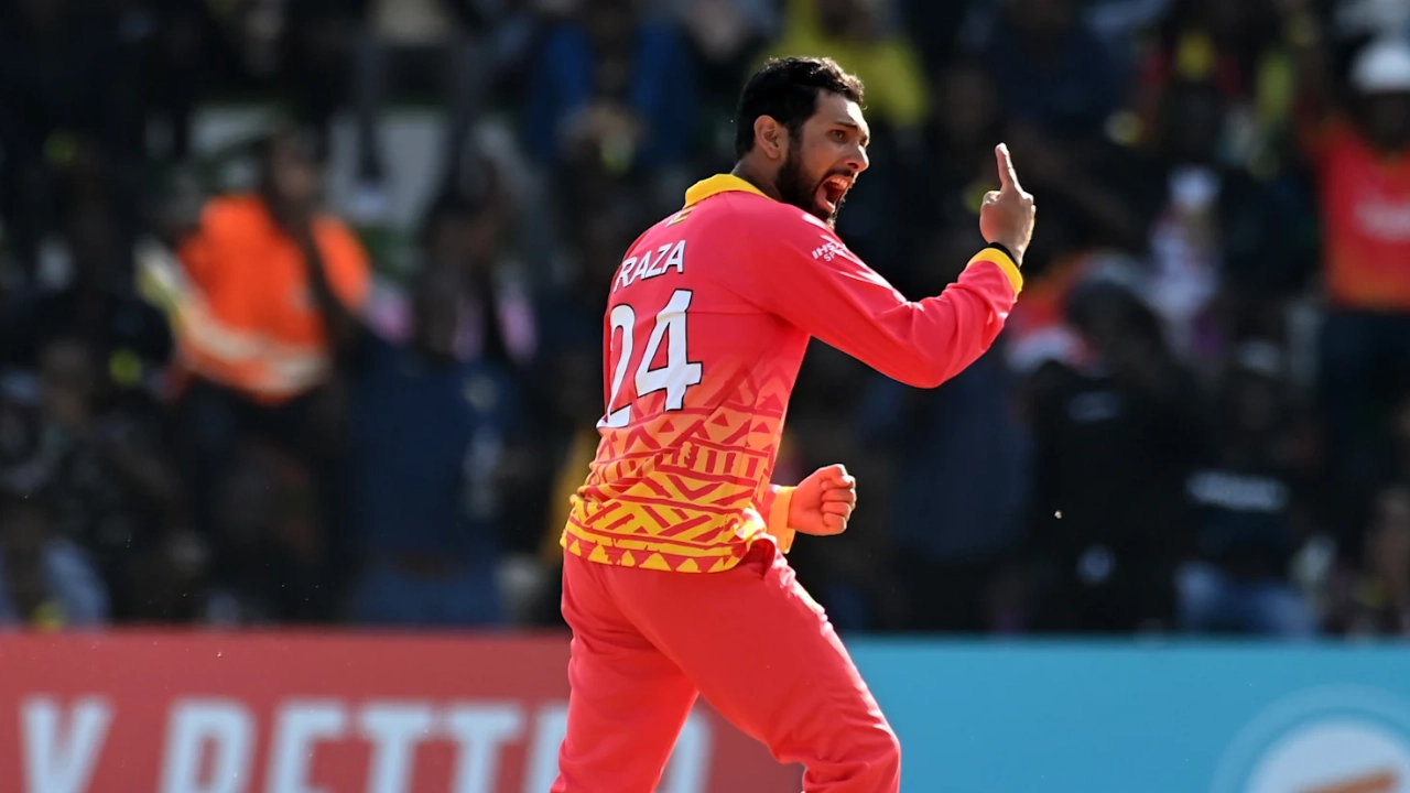 Sikandar Raza celebrates after taking a wicket, wearing the Zimbabwe cricket team jersey during a match.