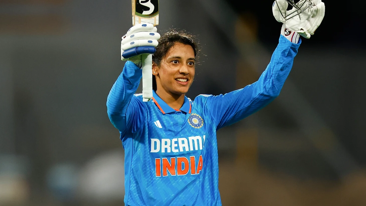 Smriti Mandhana celebrates with bat and helmet after scoring a century for India women's cricket team