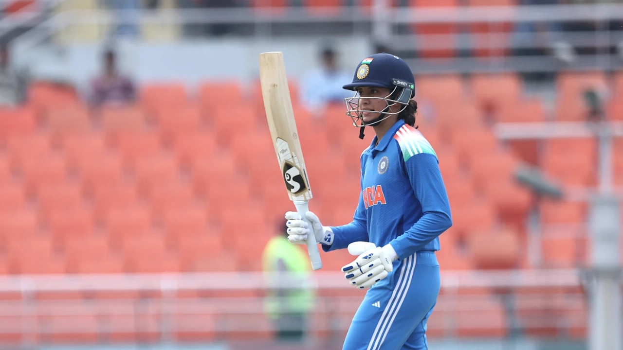Smriti Mandhana raises her bat while playing for the Indian women's cricket team during a match in 2025