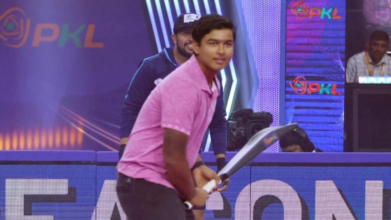 Vaibhav Sooryavanshi holding a cricket bat during a Pro Kabaddi League 2025 event appearance