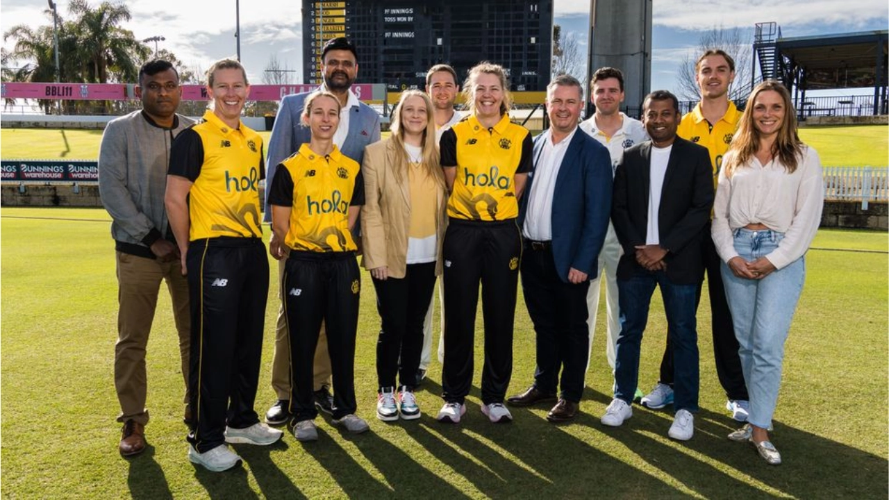 Group photo of WA Cricket players and Hola Health representatives standing together on a cricket ground to announce their official partnership for the 2025 season.