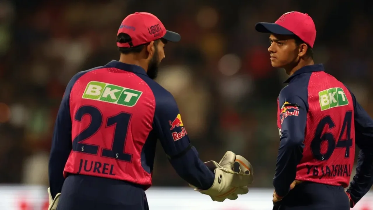 Yashasvi Jaiswal and Dhruv Jurel in Rajasthan Royals jerseys during an IPL 2025 match, discussing strategy on the field