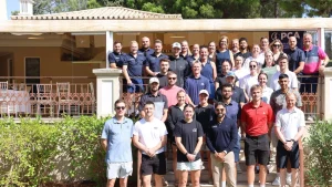 Group photo of attendees at the 2025 PCA Summit taken outdoors in front of a building under sunny weather.