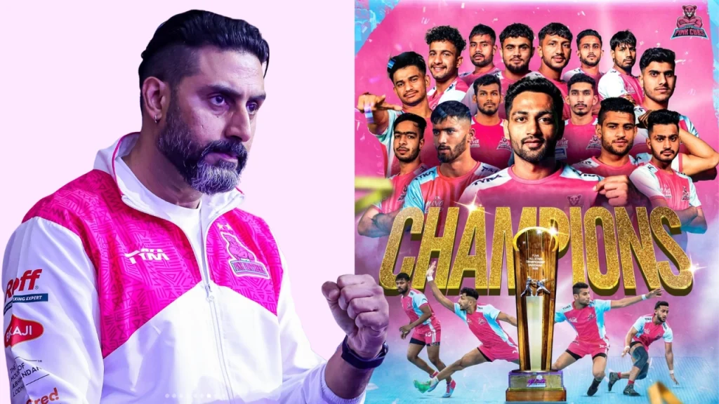 Abhishek Bachchan with Pink Cubs Kabaddi team celebrating championship win, featuring players and trophy.