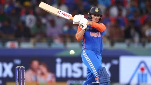 Indian cricketer Abhishek Sharma playing a shot during a T20 match in Asia Cup 2025, wearing India's blue and orange jersey.