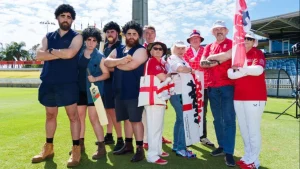 Group photo of Barmy Army cricket fans dressed in costumes and England attire at a stadium