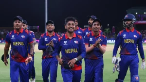 Nepal national cricket team players walking off the field after a T20 World Cup match, smiling and applauding.