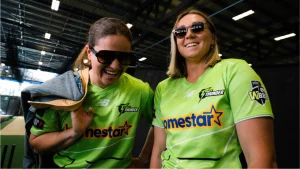 Sydney Thunder WBBL cricketers wearing New Balance playing kits and sunglasses indoors