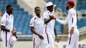 West Indies cricketers in white Test jerseys during a match, representing Cricket West Indies (CWI) in 2025.