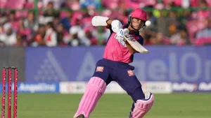Yashasvi Jaiswal playing a shot during an IPL match in pink and blue Rajasthan Royals kit.