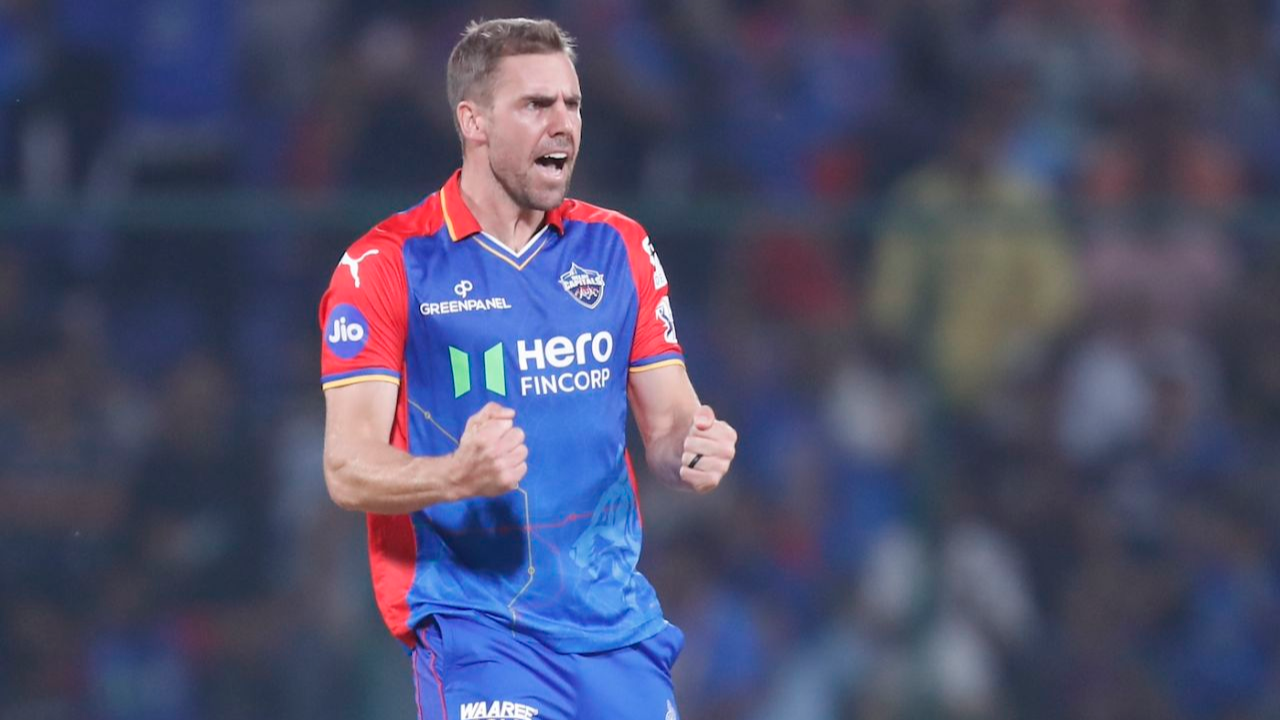 Anrich Nortje of Delhi Capitals celebrates after taking a wicket during an IPL match, wearing the team’s red and blue jersey.