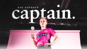 Ashleigh Gardner poses in a Sydney Sixers jersey after being named captain, standing confidently with a cricket ball in hand.