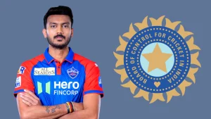Axar Patel in Delhi Capitals jersey standing with folded arms next to the BCCI logo, representing his role in Indian cricket and the IPL.