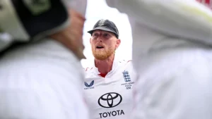 Ben Stokes leads the England team huddle during the Ashes 2025 series, wearing the official Test jersey with Ashes insignia