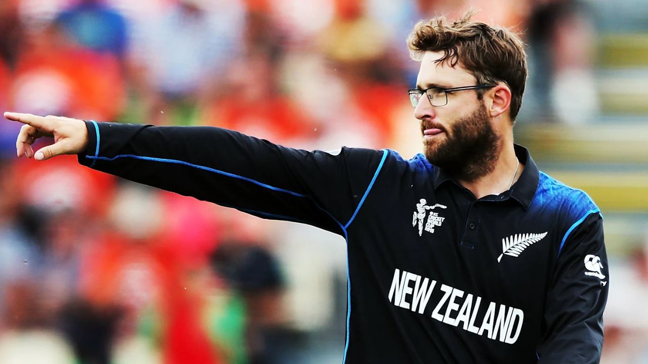 Daniel Vettori pointing during a match while wearing the New Zealand cricket team World Cup jersey.