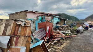Severely damaged homes and scattered debris after Hurricane Melissa swept through a Caribbean community in 2025.