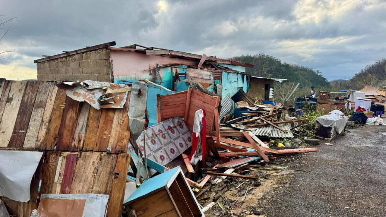 Severely damaged homes and scattered debris after Hurricane Melissa swept through a Caribbean community in 2025.