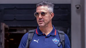 Kevin Pietersen wearing a Delhi Capitals shirt and sunglasses, possibly arriving for IPL 2025 team event.