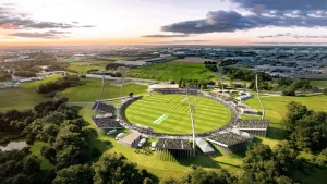 Aerial view of Nassau County International Cricket Stadium in New York, built for ICC Men’s T20 World Cup 2024, surrounded by greenery and crowds in temporary stands.