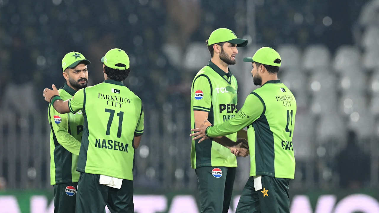 Pakistan cricket team players, including Naseem Shah and Shaheen Afridi, celebrate during a T20I match wearing the team's green and black kit.
