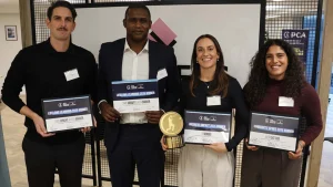 PCA Futures Awards 2025 winners Fi Morris, Naomi Dattani, Keith Barker, and Chris Wright holding their certificates and trophy at the award ceremony.