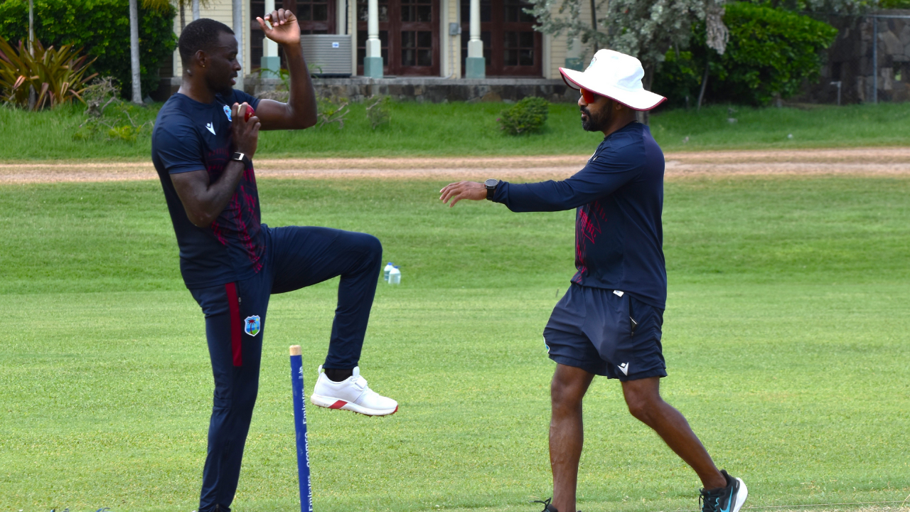 West Indies Academy head coach Ramesh Subasinghe training fast bowler Anderson Phillip during a practice session on the field.