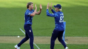 Sam Curran and Jacob Bethell celebrate on the field in England’s blue limited-overs kit, following the announcement of their central contracts in 2025.