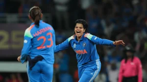 Shafali Verma celebrates with Harmanpreet Kaur during an India women's cricket team match, both wearing blue jerseys