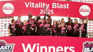 Vitality Blast 2025 men's winning team celebrating on stage with the trophy, confetti, and raised arms after the final match victory.