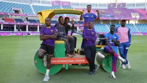 Group of African cricketers posing on a roller at Dubai International Stadium during ILT20 tournament