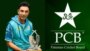 Azhar Mehmood holding a cricket trophy with the Pakistan Cricket Board (PCB) logo displayed in the background.