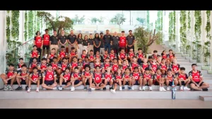 Group photo of Desert Vipers cricket academy players and coaching staff posing together in team kits at an indoor facility in 2025.