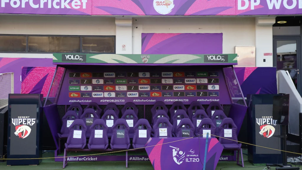 Desert Vipers team dugout and rostrum featuring ILT20 and sponsor branding at a DP World ILT20 match venue.
