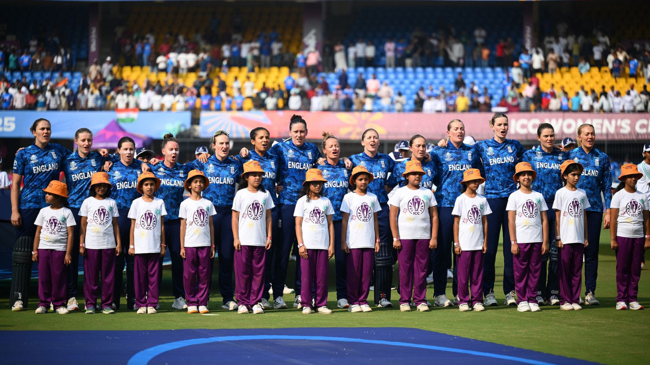 England Women’s cricket team with young children during the anthem ceremony at the ICC Women’s Cricket World Cup 2025.