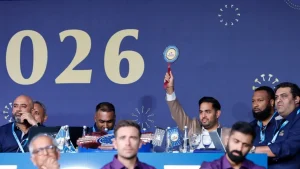 Akash Ambani raises bidding paddle alongside Kieron Pollard and Mahela Jayawardene during the IPL 2026 auction.