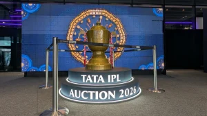 IPL 2026 trophy on display at Etihad Arena with illuminated platform and decorative background during the player auction event