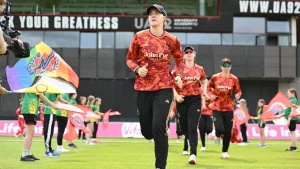 Kirstie Gordon leads her women’s cricket team onto the field ahead of a match during a pre-game walkout.