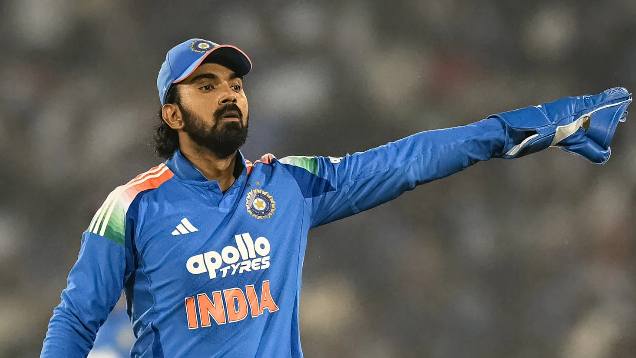 KL Rahul in India cricket jersey and wicketkeeping gloves pointing during a match.