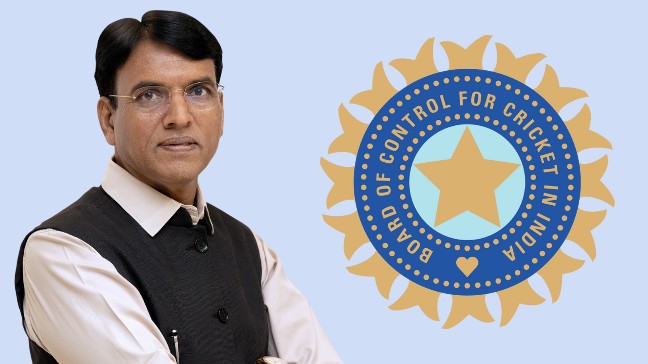Mansukh Mandaviya standing beside the BCCI logo on a light blue background
