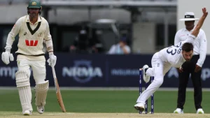 England fast bowler Mark Wood in action during Ashes 2025 Test match against Australia, with Australian batter and umpire watching
