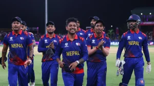 Nepal cricket team players walking off the field celebrating after a T20 match under stadium lights
