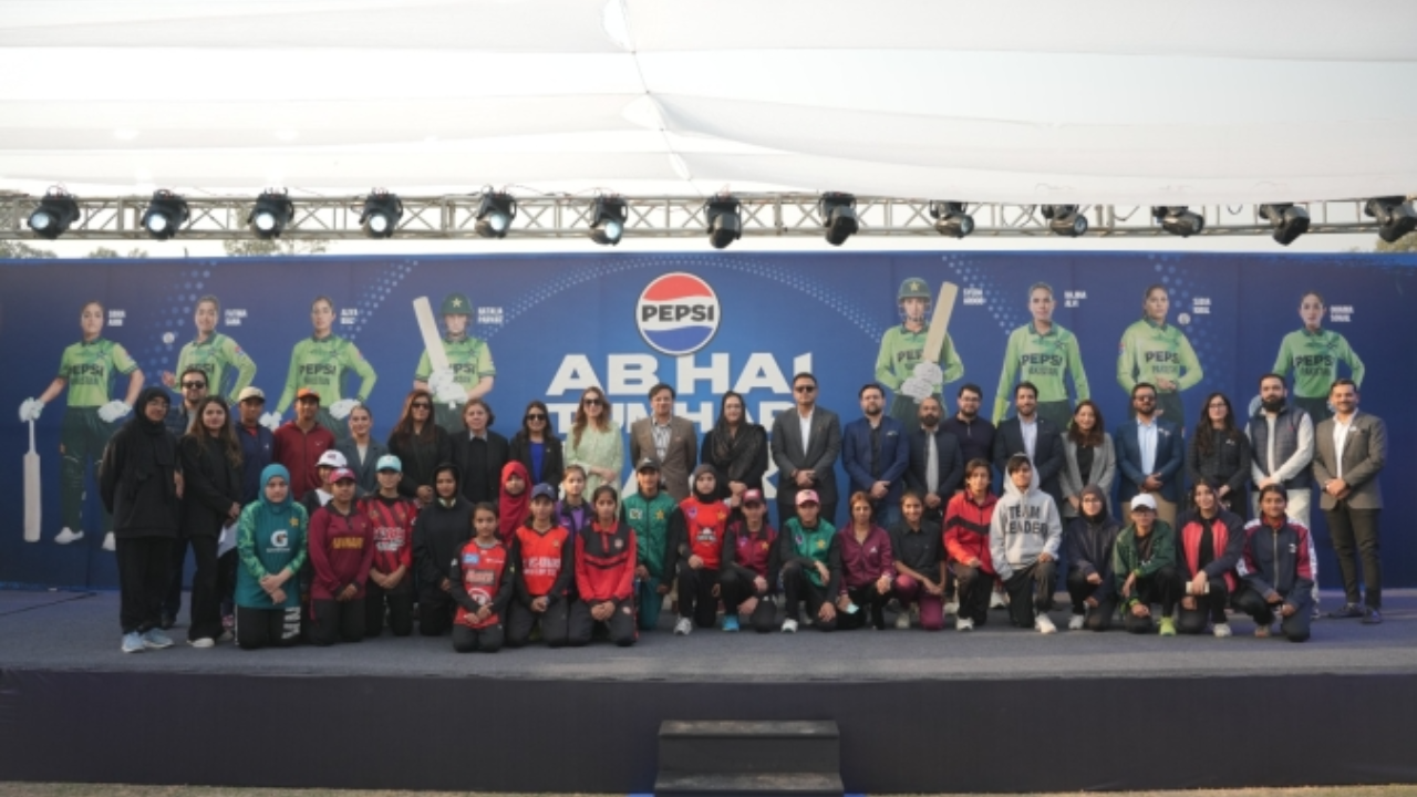 Group photo from PCB and Pepsi collaboration event promoting women's cricket, featuring players, officials, and a promotional backdrop with women cricketers