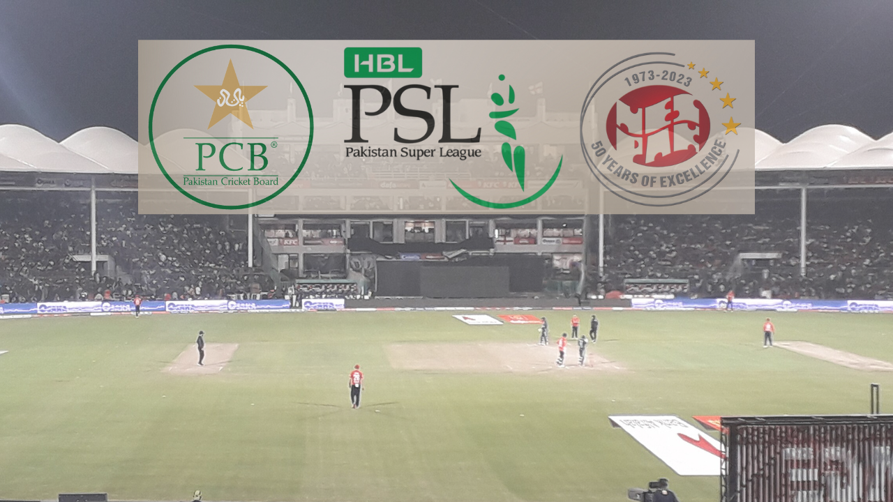 Night view of a cricket match at National Stadium Karachi with NESPAK, PSL, and PCB logos prominently displayed, showcasing a packed crowd and illuminated playing field during the Pakistan Super League.