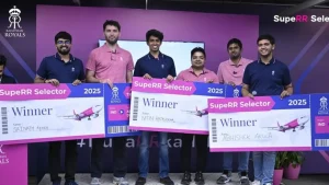 Winners of the Rajasthan Royals SupeRR Selector 2025 holding large boarding pass-style winner cheques during a presentation event