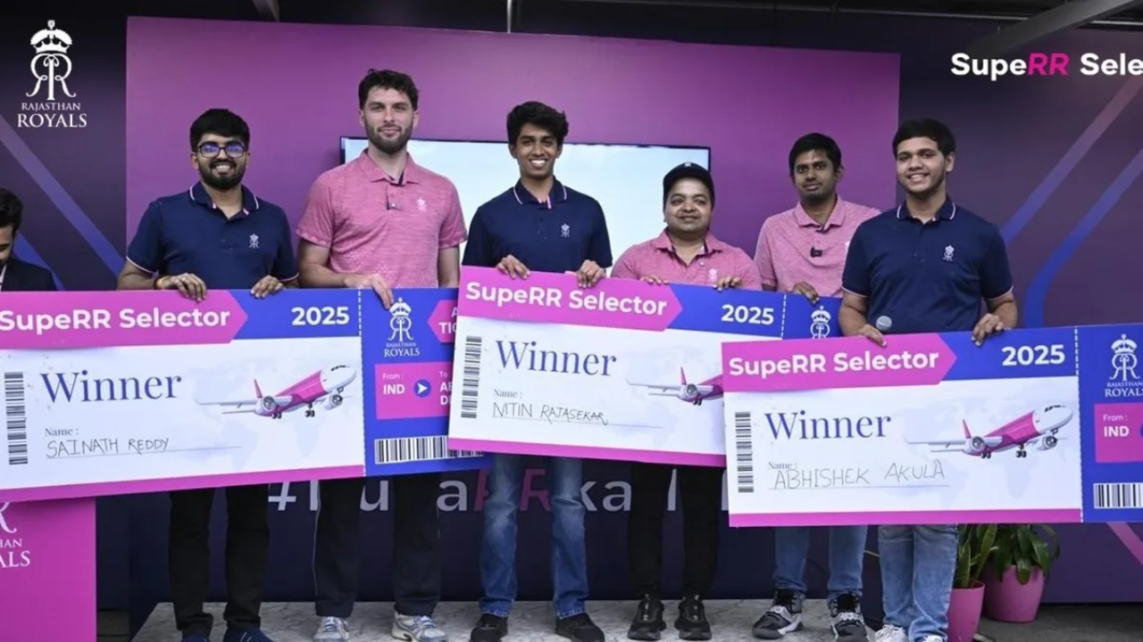 Winners of the Rajasthan Royals SupeRR Selector 2025 holding large boarding pass-style winner cheques during a presentation event