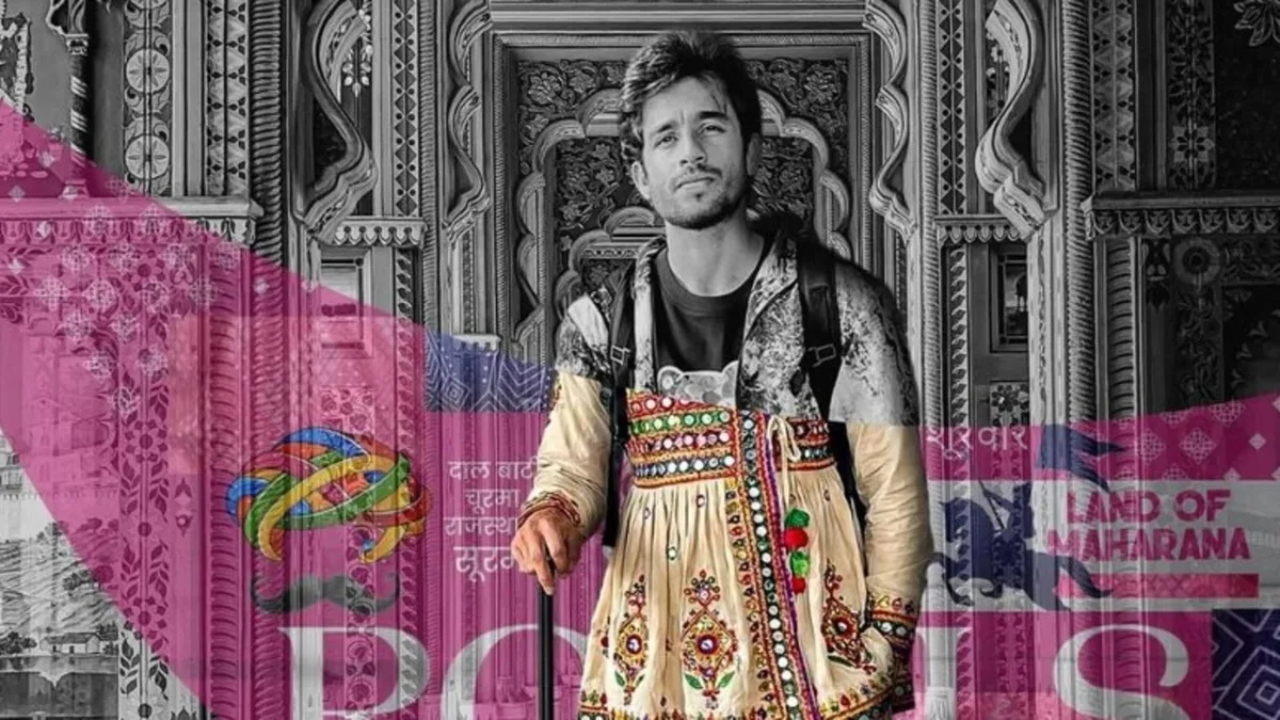 Ravi Bishnoi poses in traditional Rajasthani attire against an intricately designed heritage backdrop.