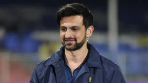 Former Pakistan cricketer Shoaib Malik smiles during an ICC cricket event at a stadium.