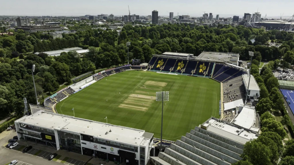 Aerial view of Sophia Gardens cricket stadium in Cardiff, surrounded by trees with the city skyline in the background