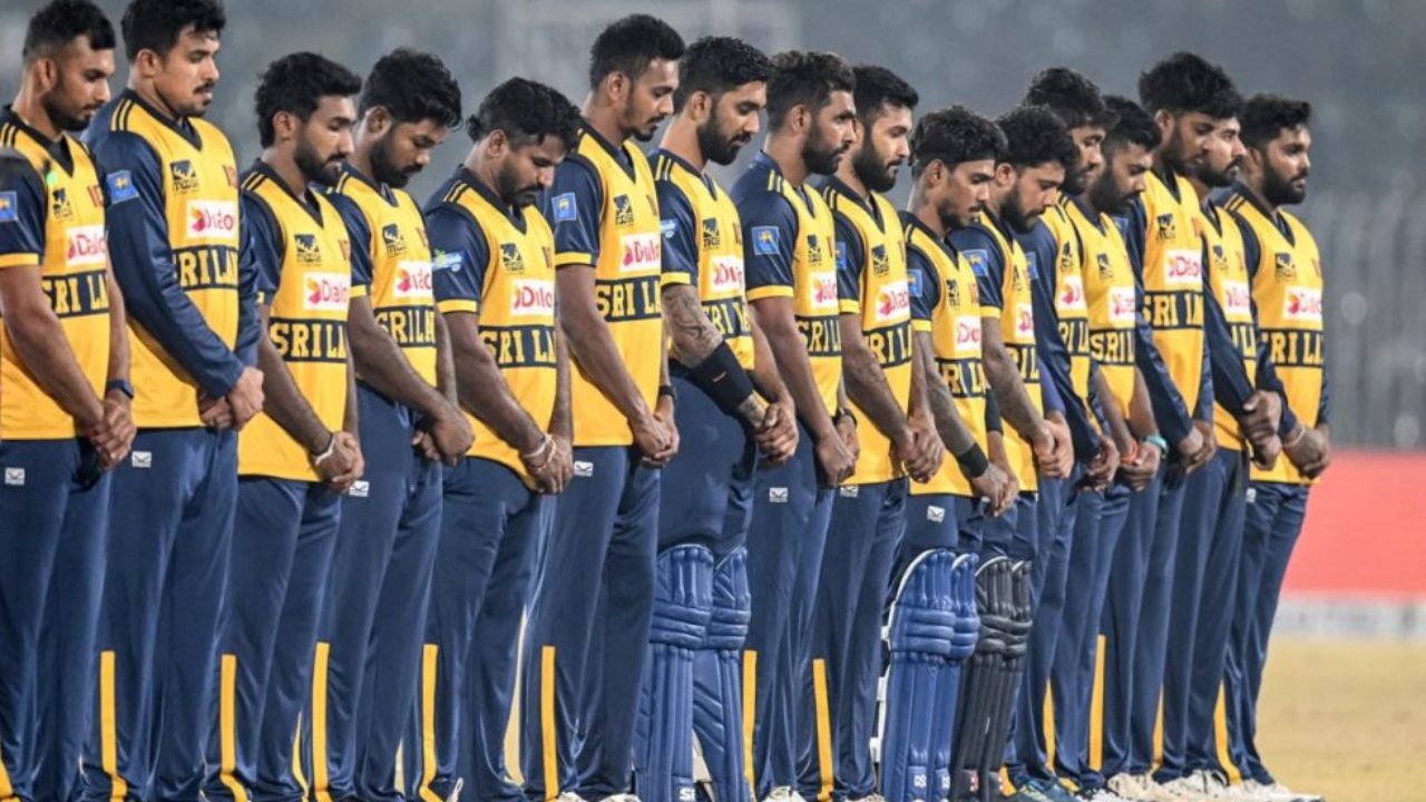 Sri Lankan cricket team observes a moment of silence before a match, all players in uniform standing in line with heads bowed